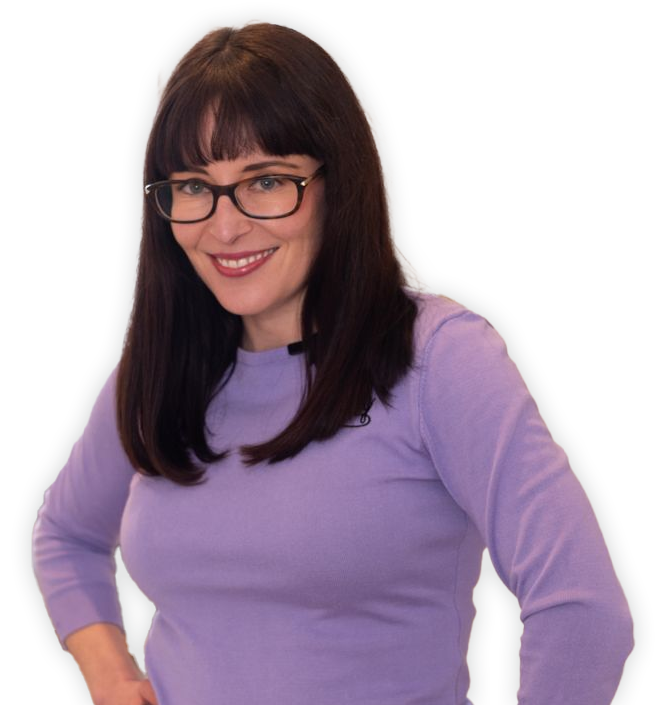 Sexologist Lauren Muratore wearing a lavender shirt and glasses with hands on hips smiling with no background.